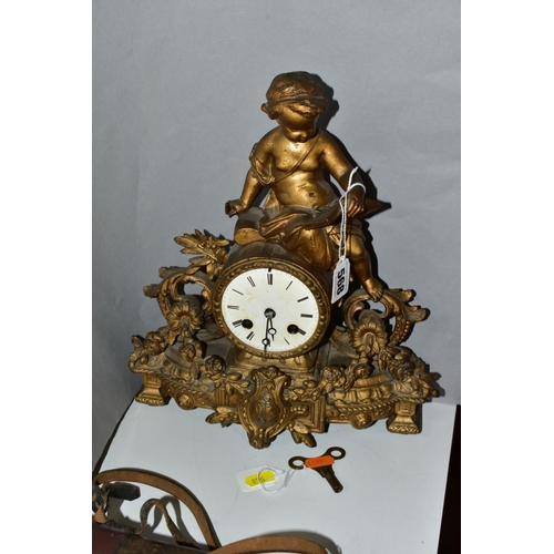 568 - A LATE 19TH CENTURY FRENCH GILT METAL FIGURAL MANTEL CLOCK, the case cast with a putti holding an op... 