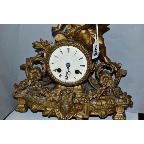 568 - A LATE 19TH CENTURY FRENCH GILT METAL FIGURAL MANTEL CLOCK, the case cast with a putti holding an op... 