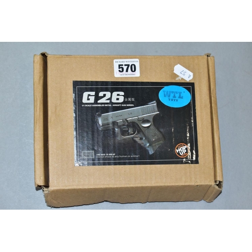 570 - A BOXED G26 AIRSOFT GUN, blue, manufactured in China, with a small quantity of balls (PURCHASER MUST... 