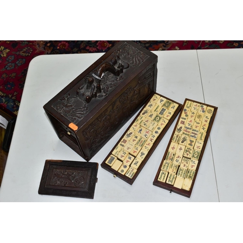 573 - A LATE 19TH/EARLY 20TH CENTURY MAH JONG SET, the bone and bamboo playing pieces housed in a relief c... 