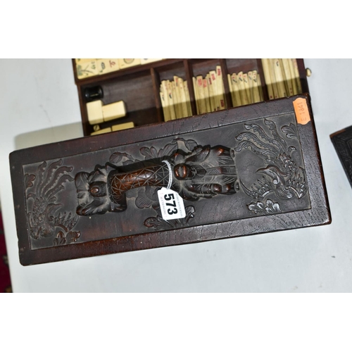 573 - A LATE 19TH/EARLY 20TH CENTURY MAH JONG SET, the bone and bamboo playing pieces housed in a relief c... 