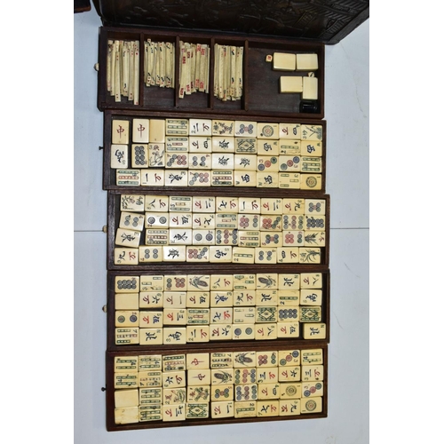 573 - A LATE 19TH/EARLY 20TH CENTURY MAH JONG SET, the bone and bamboo playing pieces housed in a relief c... 