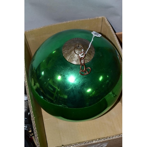 578 - A LATE 19TH/EARLY 20TH CENTURY METALLIC GREEN GLASS WITCH'S BALL with metal mount and short length o... 