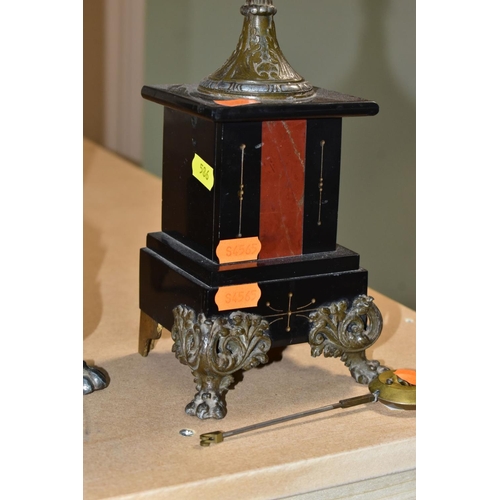 586 - A LATE 19TH CENTURY BLACK SLATE, MARBLE AND BRONZED CLOCK GARNITURE, the clock with figural surmount... 