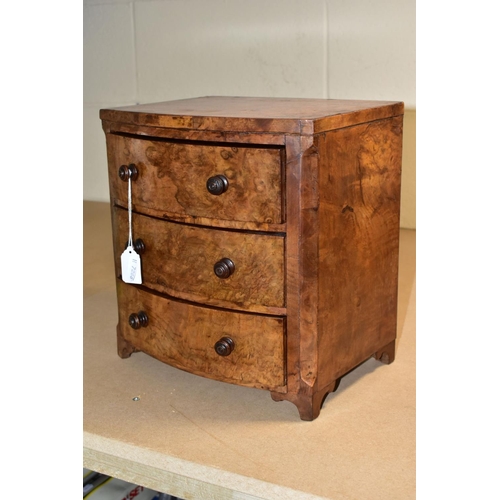 588 - A VICTORIAN BURR WALNUT VENEERED MINIATURE BOW FRONT CHEST OF THREE DRAWERS, turned wooden handles, ... 