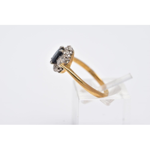 60 - A LATE 20TH CENTURY 18CT GOLD SAPPHIRE AND DIAMOND OVAL CLUSTER RING, centring on a mixed cut sapphi... 