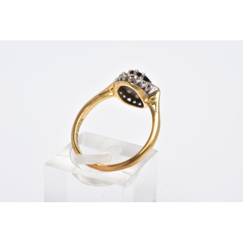 60 - A LATE 20TH CENTURY 18CT GOLD SAPPHIRE AND DIAMOND OVAL CLUSTER RING, centring on a mixed cut sapphi... 