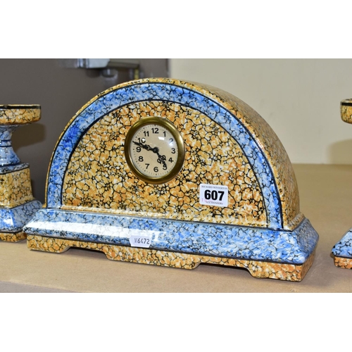 607 - A CONTINENTAL CLOCK GARNITURE, the dome shaped  porcelain clock is branded M.W inside a triangle, ap... 