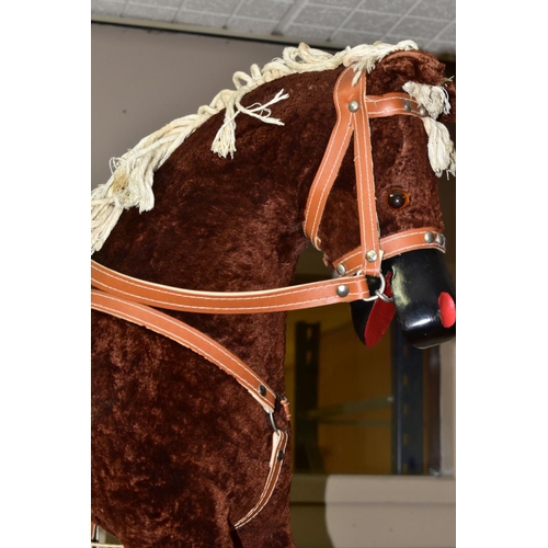 636 - A MODERN WOODEN ROCKING HORSE, covered in brown plush with string tail and mane, painted mouth, nose... 