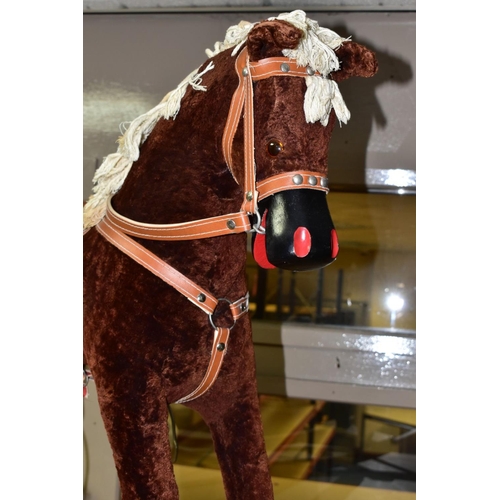 636 - A MODERN WOODEN ROCKING HORSE, covered in brown plush with string tail and mane, painted mouth, nose... 