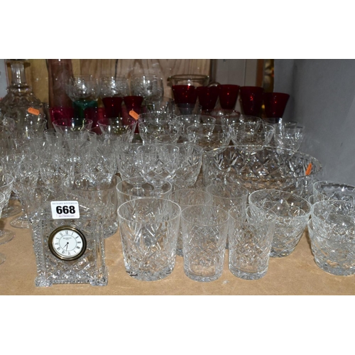 668 - A QUANTITY OF GLASSWARE, including a Waterford Crystal quartz mantel clock, height 11cm, coloured an... 