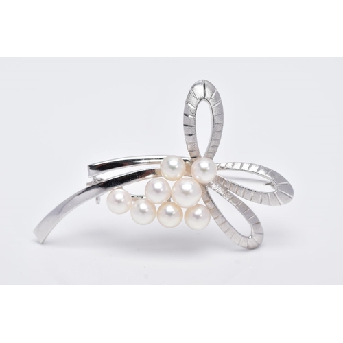 68 - A MIKIMOTO CULTURED PEARL BROOCH, eight cultured pearls set to two arched scroll textured sections, ... 