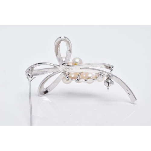 68 - A MIKIMOTO CULTURED PEARL BROOCH, eight cultured pearls set to two arched scroll textured sections, ... 