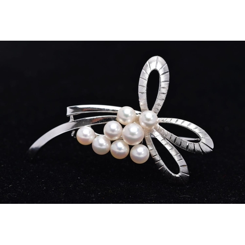 68 - A MIKIMOTO CULTURED PEARL BROOCH, eight cultured pearls set to two arched scroll textured sections, ... 