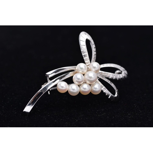 68 - A MIKIMOTO CULTURED PEARL BROOCH, eight cultured pearls set to two arched scroll textured sections, ... 