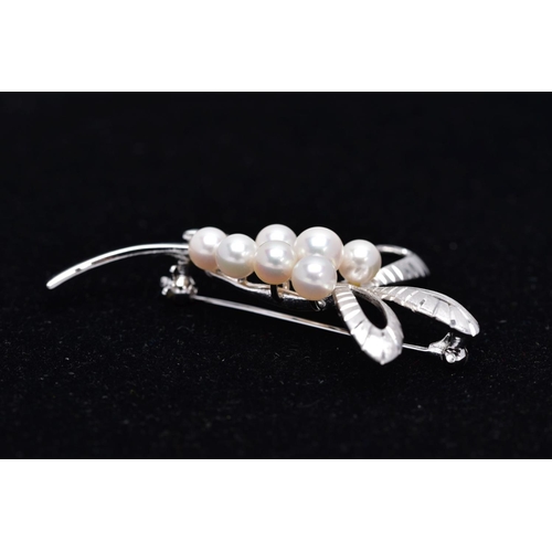 68 - A MIKIMOTO CULTURED PEARL BROOCH, eight cultured pearls set to two arched scroll textured sections, ... 