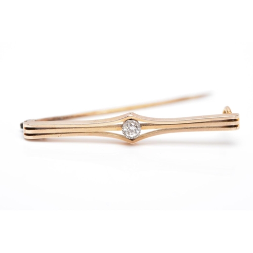 7 - A YELLOW METAL DIAMOND BROOCH, openwork bar brooch set with a round brilliant cut diamond within a m... 