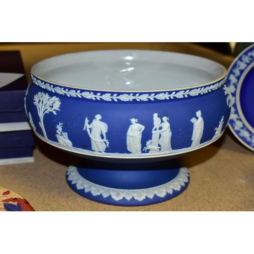 734 - THREE PIECES OF WEDGWOOD BLUE JASPERWARE, comprising a pedestal fruit bowl, the applied decoration o... 