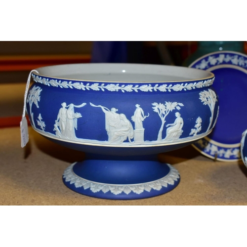 734 - THREE PIECES OF WEDGWOOD BLUE JASPERWARE, comprising a pedestal fruit bowl, the applied decoration o... 