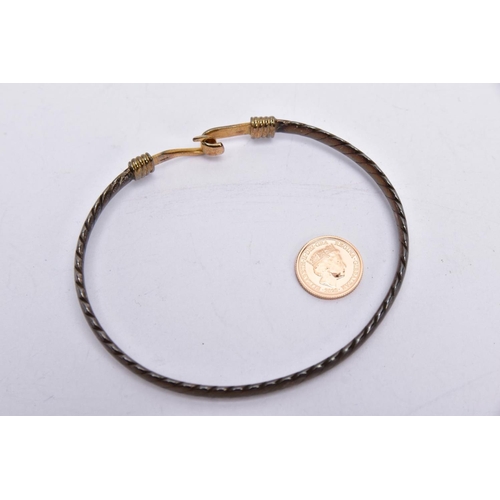 79 - A SILVER AND 18CT GOLD BANGLE WITH A YELLOW METAL COIN, the silver bangle of a rope twist design hal... 