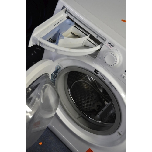 1077 - A HOTPOINT SMART TECH WMFUG 742 WASHING MACHINE (PAT pass and powers up, power cable very short)