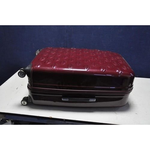 1083 - A LULU GUINESS HARD SHELL SUITCASE in Burgundy and 4 wheels, width 50cm x depth 30cm x height 79cm