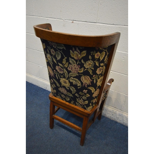 1202 - AN ARTS AND CRAFTS OAK ORKNEY CHAIR, black and florally upholstered back and matching removable cush... 