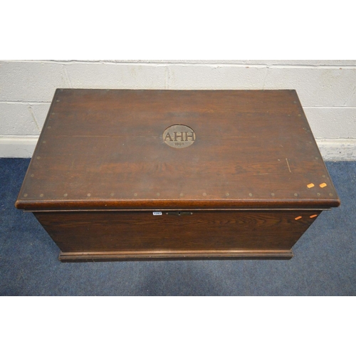 1207 - AN EARLY 20TH CENTURY OAK BLANKET CHEST, initialled 'AHH, 1904' to the lid, with twin brass handles,... 