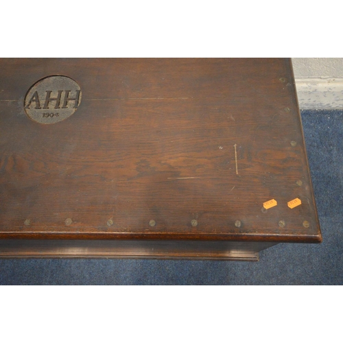 1207 - AN EARLY 20TH CENTURY OAK BLANKET CHEST, initialled 'AHH, 1904' to the lid, with twin brass handles,... 