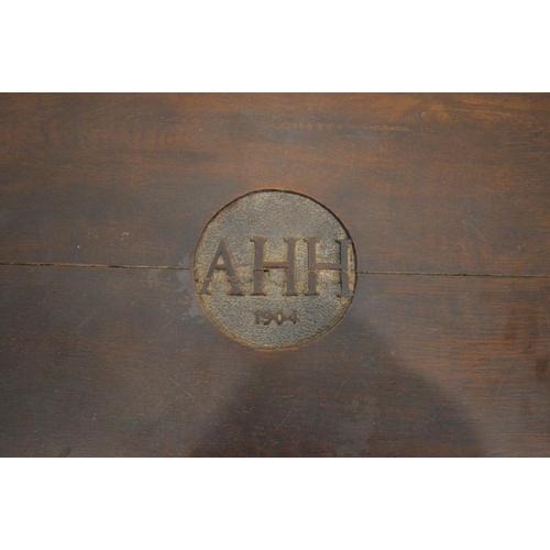 1207 - AN EARLY 20TH CENTURY OAK BLANKET CHEST, initialled 'AHH, 1904' to the lid, with twin brass handles,... 