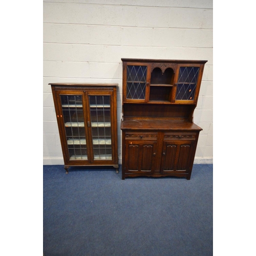 1209 - AN EARLY 20TH OAK LEAD GLAZED BOOKCASE, the double doors enclosing three adjustable shelves, on fron... 