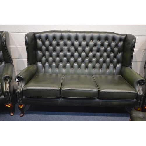 1213 - A FOUR PIECE GREEN LEATHER CHESTERFIELD SUITE, comprising a winged settee, width 170cm and a pair of... 