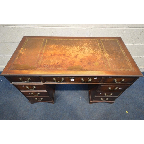 1222 - AN EARLY 20TH CENTURY MAHOGANY PEDESTAL DESK, with a triple leather tooled top with nine assorted dr... 