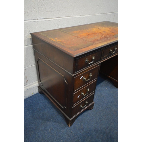 1222 - AN EARLY 20TH CENTURY MAHOGANY PEDESTAL DESK, with a triple leather tooled top with nine assorted dr... 