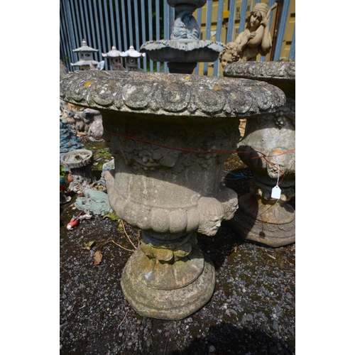 908 - A PAIR OF COMPOSITE CAMPANA GARDEN URNS, with fruiting vine decoration and male masks, on a separate... 