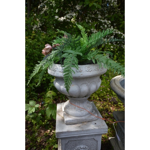 928 - A GREY COMPOSITE GARDEN URN, on a separate plinth, diameter 56cm x height 68cm x height of plinth 35... 