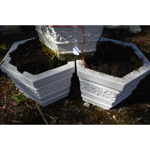 931 - A SET OF FOUR COMPOSITE HEXAGONAL PLANTERS, later painted white, diameter 33cm x height 26cm