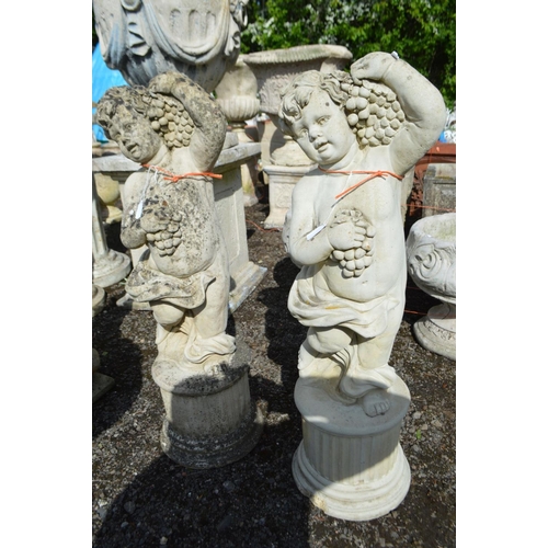 952 - A PAIR OF COMPOSITE PUTTO GARDEN FIGURES, holding a bunch of grapes, height 88cm (chip to bottom rim... 