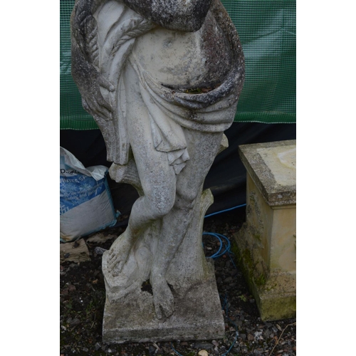 960 - A LARGE WEATHERED COMPOSITE GARDEN STATUE of a semi clad lady in flowing robes, collecting the crops... 