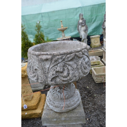 971 - A PAIR OF COMPOSITE GARDEN PLANTERS with acanthus leaf detail, on a tall matched plinth, diameter 46... 