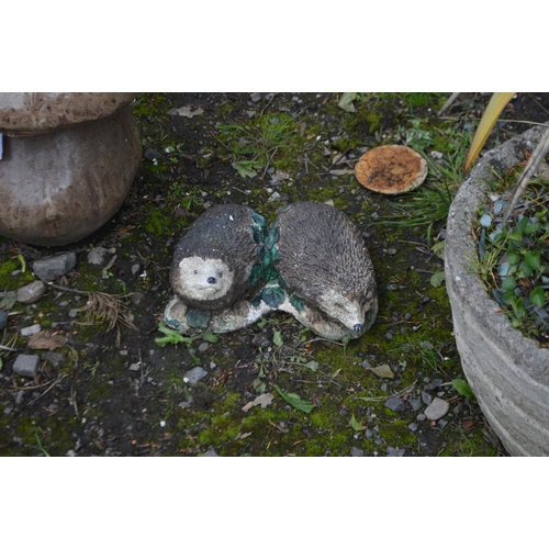 974 - A PAIR OF GLAZED GARDEN MUSHROOMS, along with a garden ornament of two hedgehogs and a small plant p... 