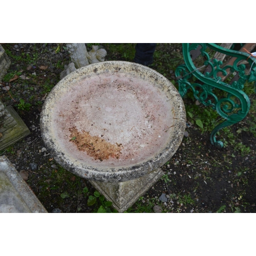 977 - A COMPOSITE CIRCULAR BIRD BATH on a separate pillar base with foliate decoration, diameter 50cm x he... 