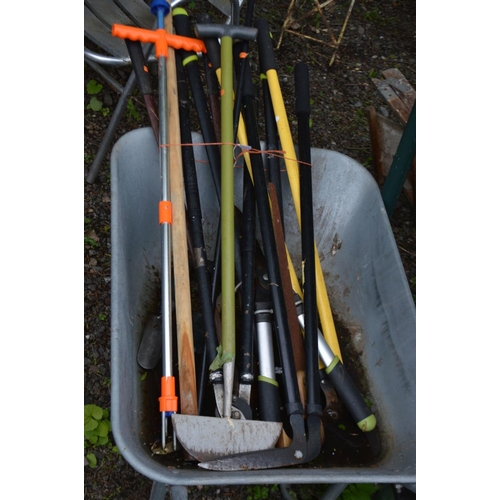 989 - A GALVANISED WHEELBARROW, containing a collection of garden hand tools, two wooden step ladders and ... 