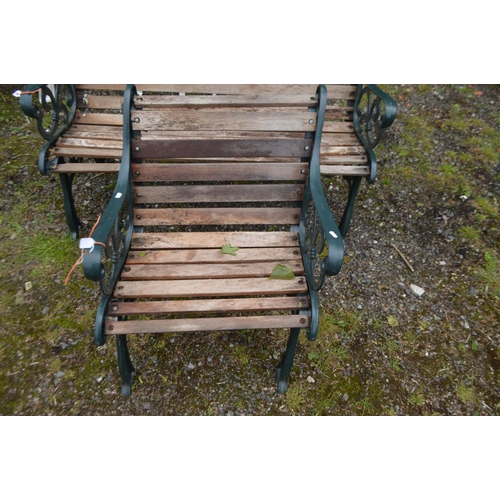 994 - A CAST IRON GREEN PAINTED GARDEN BENCH with teak slats, length 130cm and a matching armchair, length... 