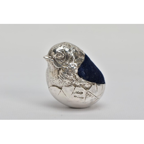 1 - AN EARLY 20TH CENTURY SILVER PIN CUSHION, in the form of a realistically textured hatching chick, bl... 