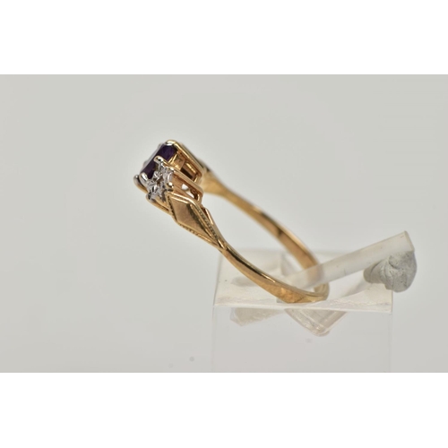 11 - A 9CT GOLD THREE STONE RING, centring on a claw set, oval cut amethyst, flanked with illusion set si... 