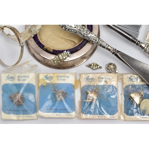 111 - A SELECTION OF SILVER AND WHITE METAL ITEMS, to include four 'Nuvo' sterling silver charms in origin... 