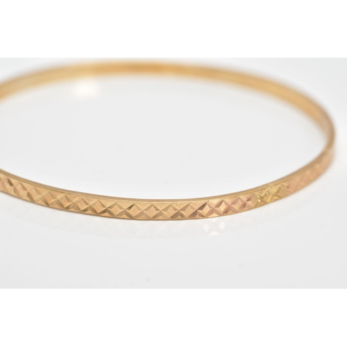 119 - A 9CT YELLOW GOLD BANGLE, textured design all round, hallmarked 9ct gold Sheffield, approximate inne... 