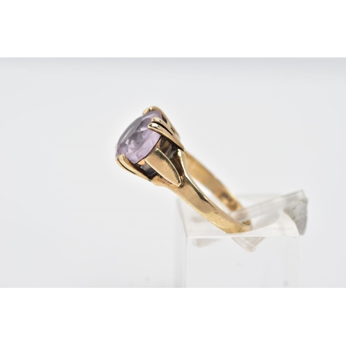 136 - A 9CT GOLD AMETHYST RING, designed with a double four claw set circular cut amethyst, textured shoul... 