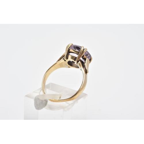 136 - A 9CT GOLD AMETHYST RING, designed with a double four claw set circular cut amethyst, textured shoul... 